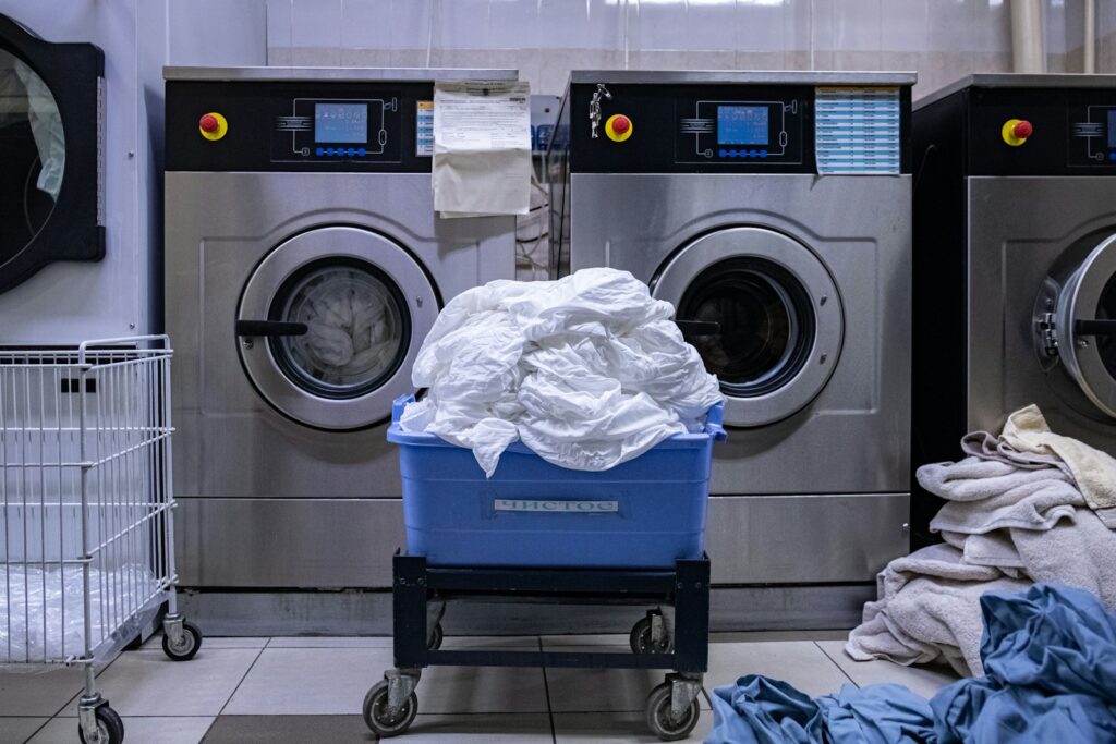 a laundry room with a washing machine and a laundry basket